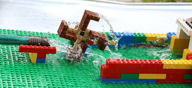 Kids learning engineering with Lego water wheel